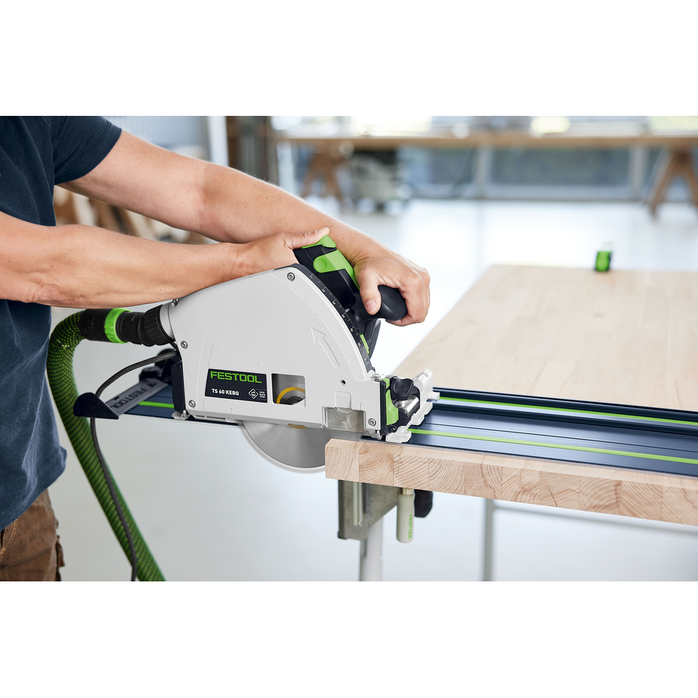 Person using Festool branded circular saw with blue and green guide rail cutting a wooden board for home improvement