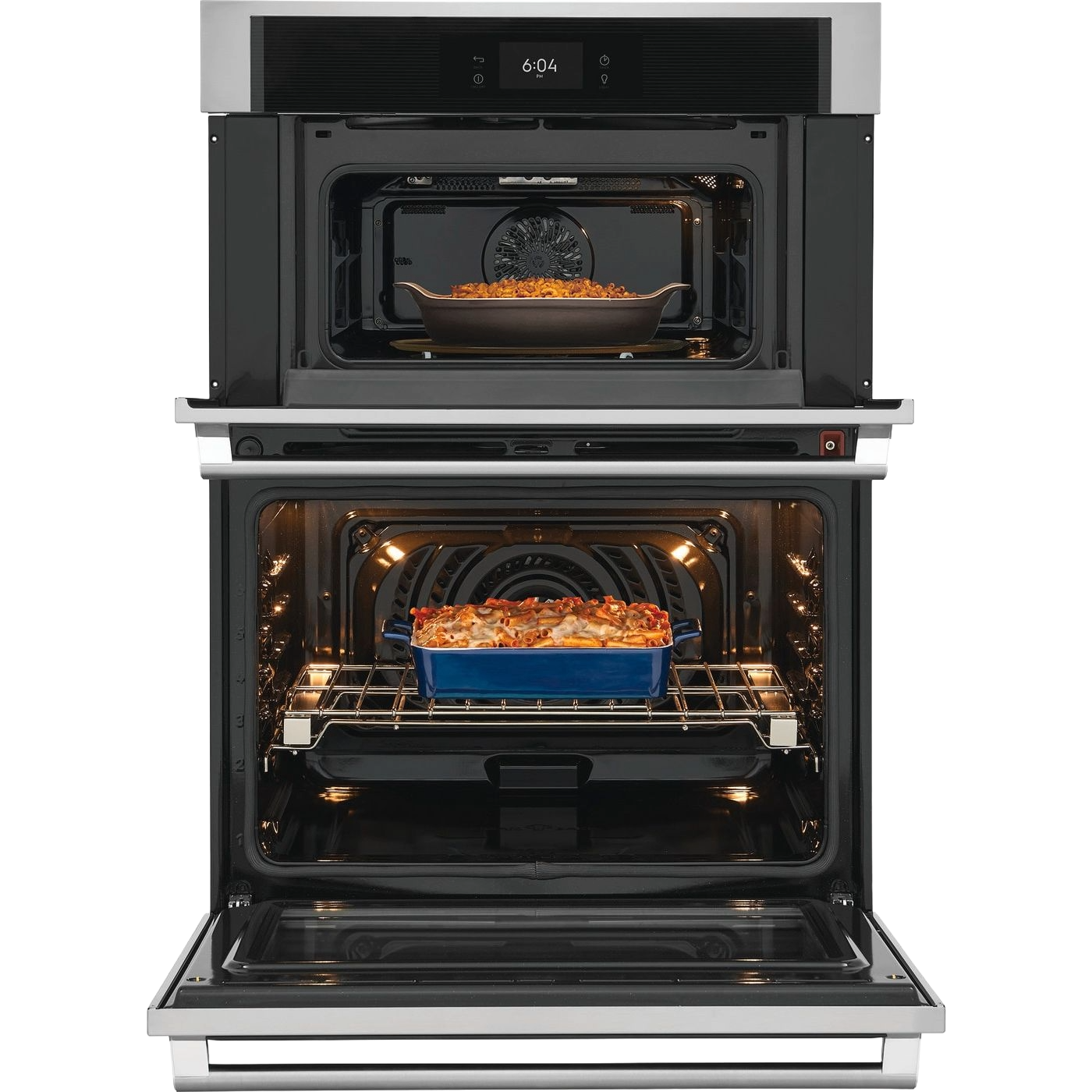 Open stainless steel wall oven and microwave combo with cooked dishes inside in modern kitchen appliances setting