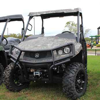 Mid-size camouflage crossover utility vehicle with rugged tires, front bumper, and off-road suspension for outdoor use