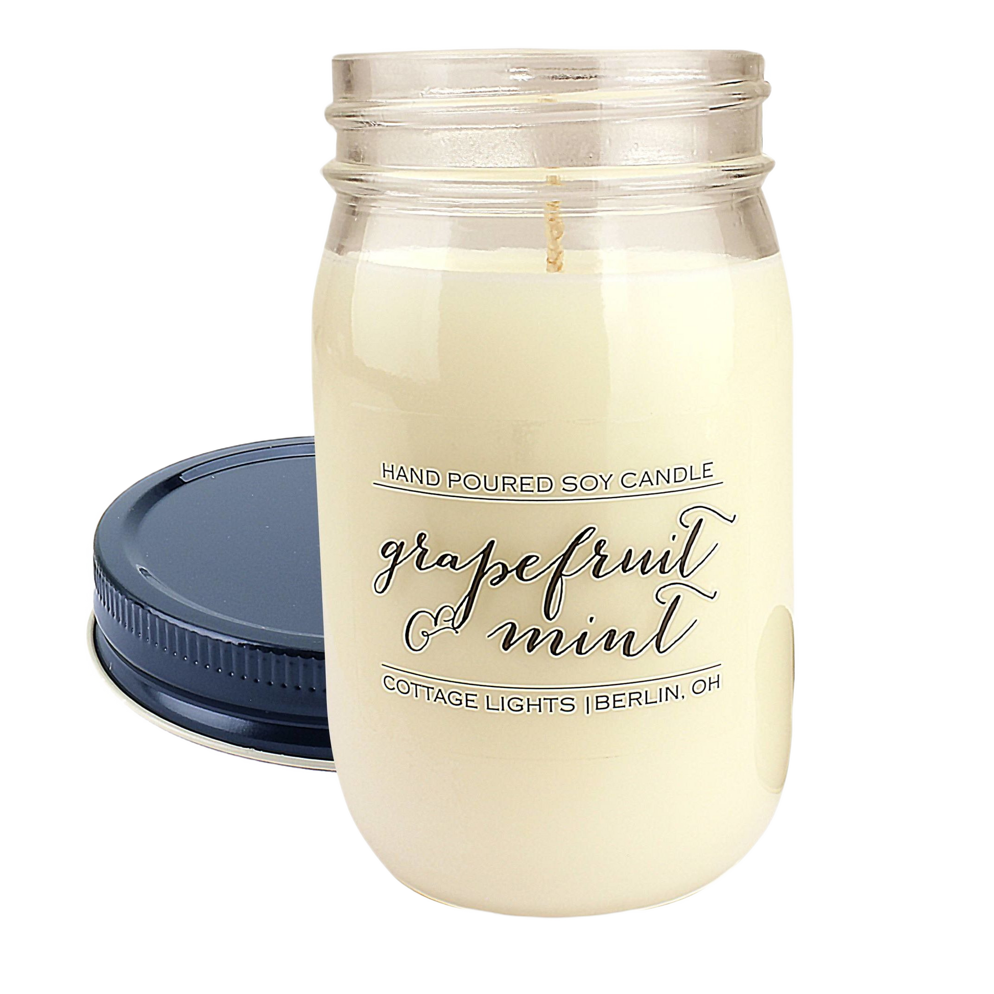 16 oz soy candle in a clear jar with navy lid, featuring grapefruit and mint scent for home ambiance