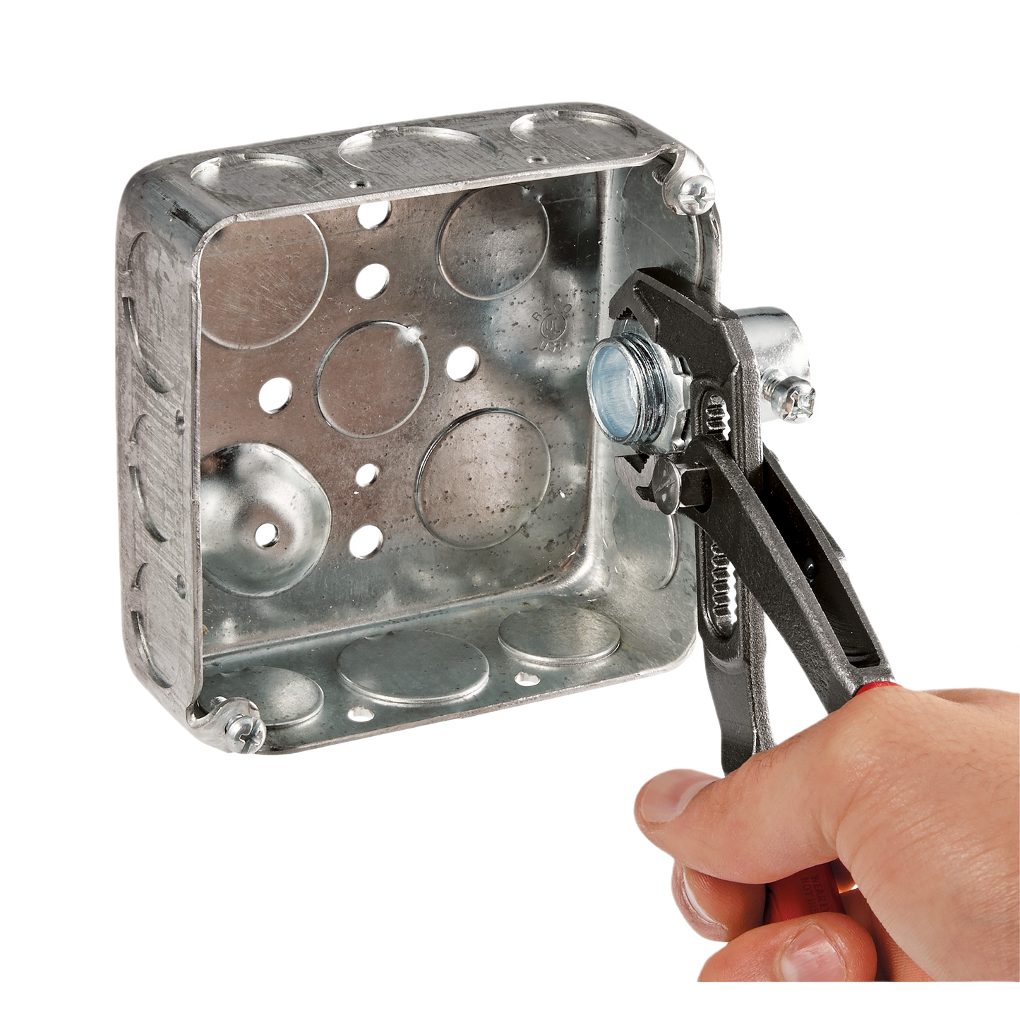 Hand using Milwaukee 10-inch comfort grip pliers to tighten a metal nut on electrical junction box for home improvement