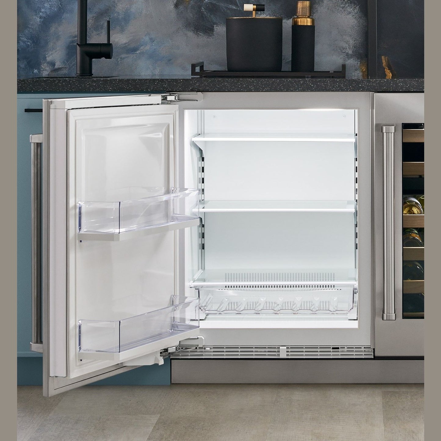 Open undercounter refrigerator with left hinge and illuminated adjustable shelves in kitchen appliances and Refrigerators collections