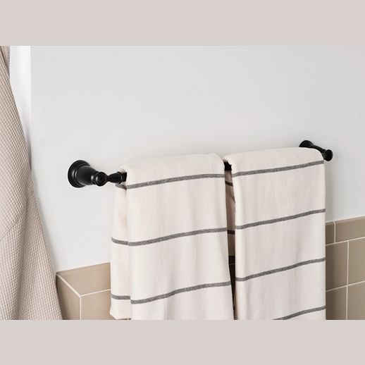Matte black towel bar holding two white towels with gray stripes in a modern bathroom setting for home improvement