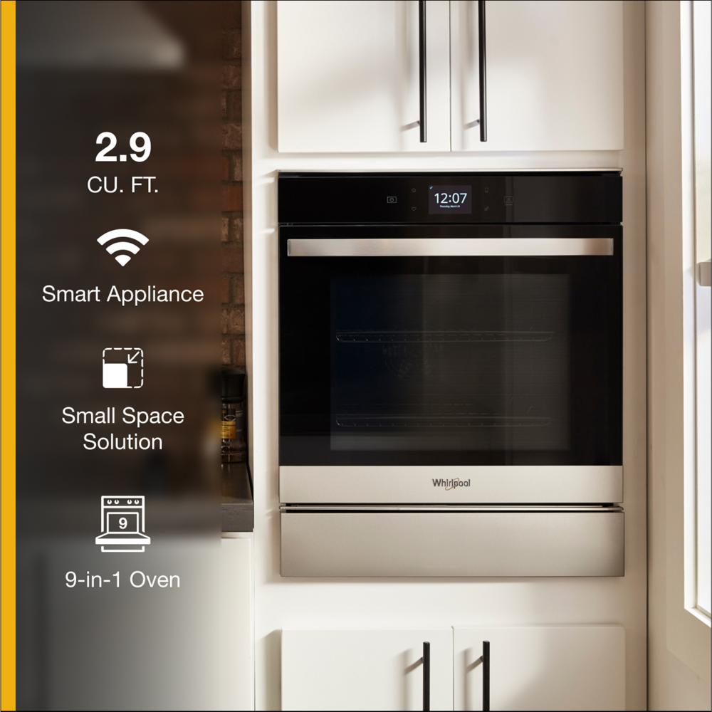 Built-in stainless steel convection wall oven with digital display and modern cabinetry in kitchen setting