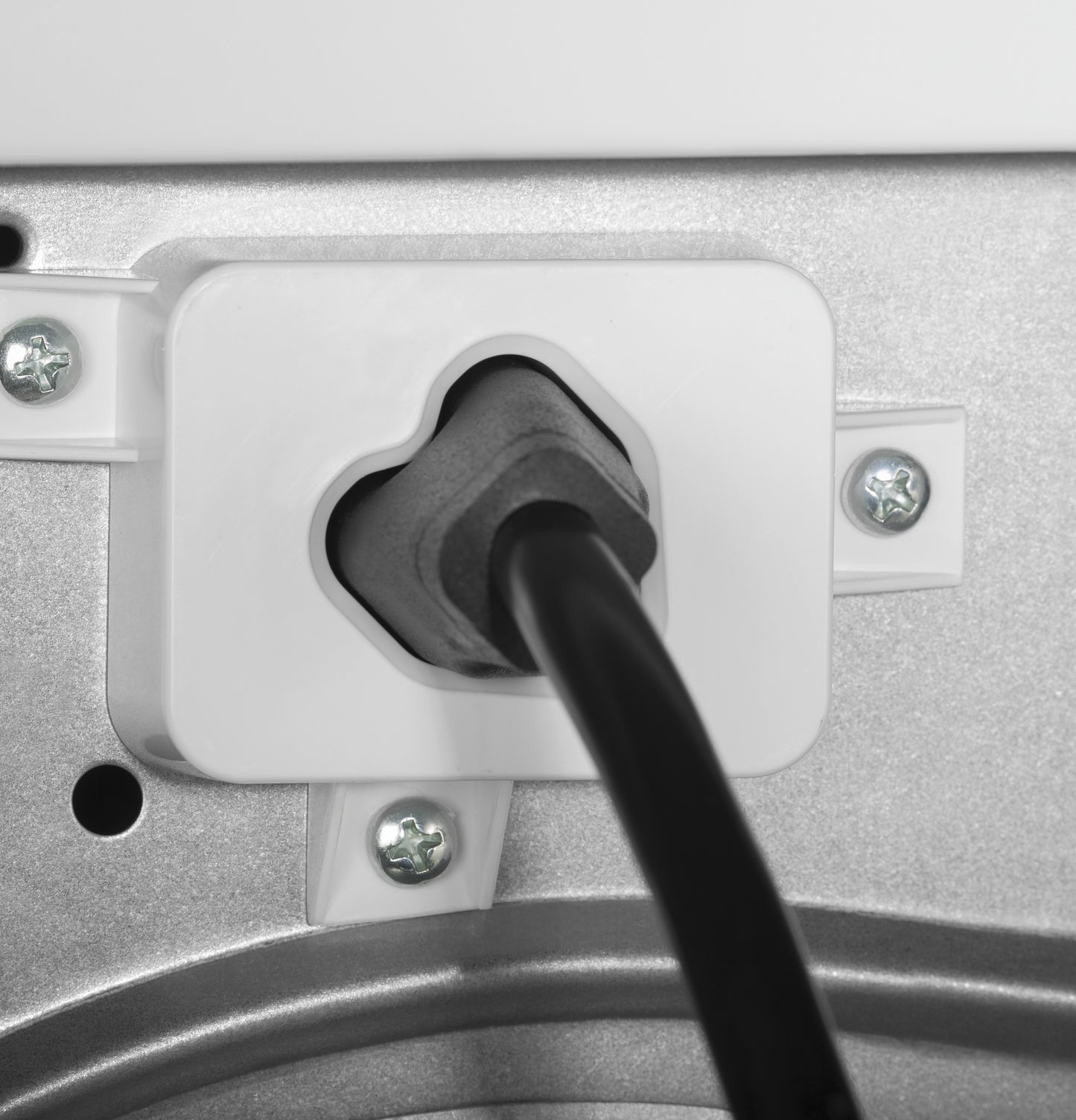Close-up of vented electric dryer power cord plugged into a secure white plastic outlet housing in appliance panel