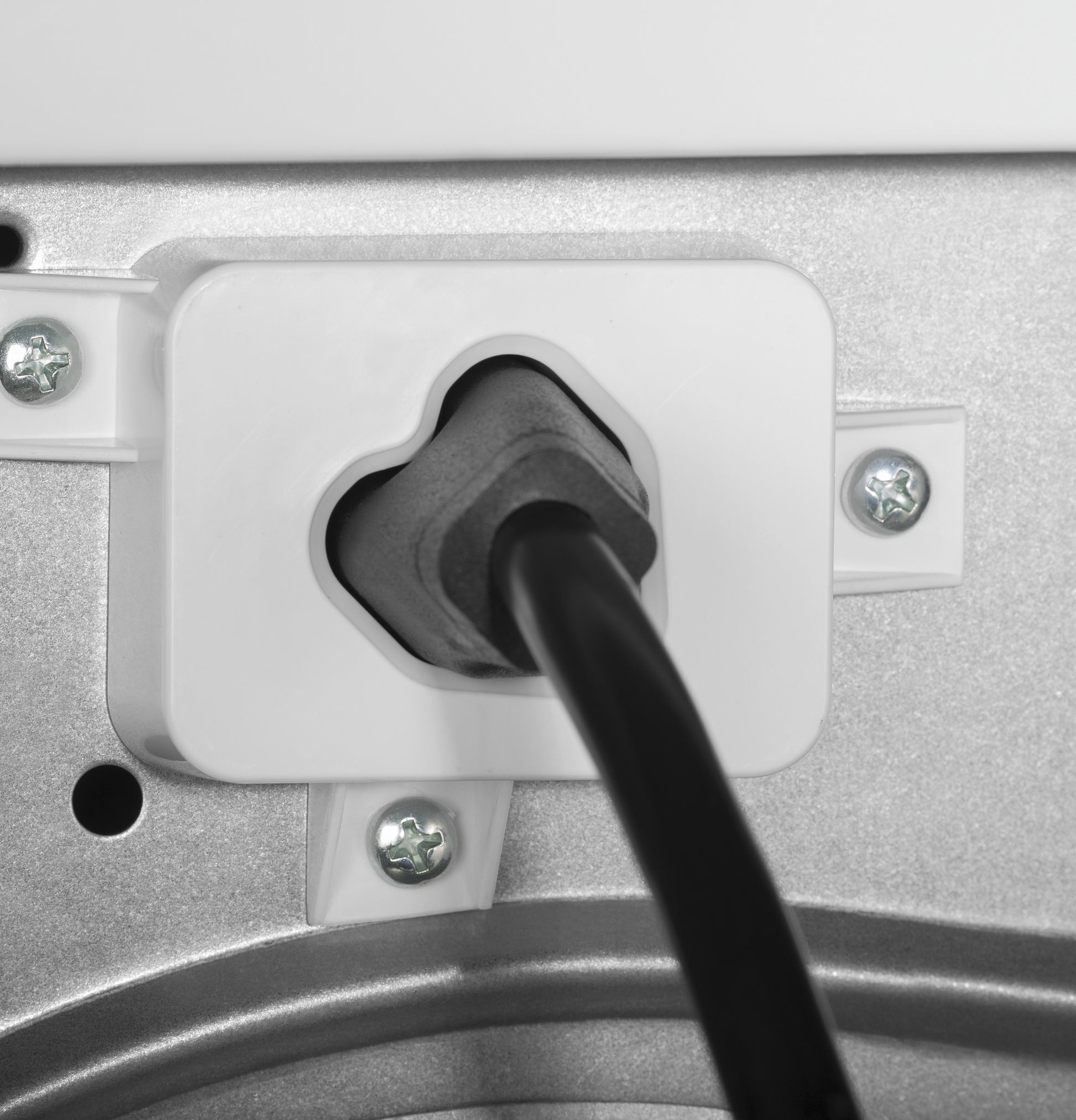Close-up of vented electric dryer power cord plugged into a secure white plastic outlet housing in appliance panel