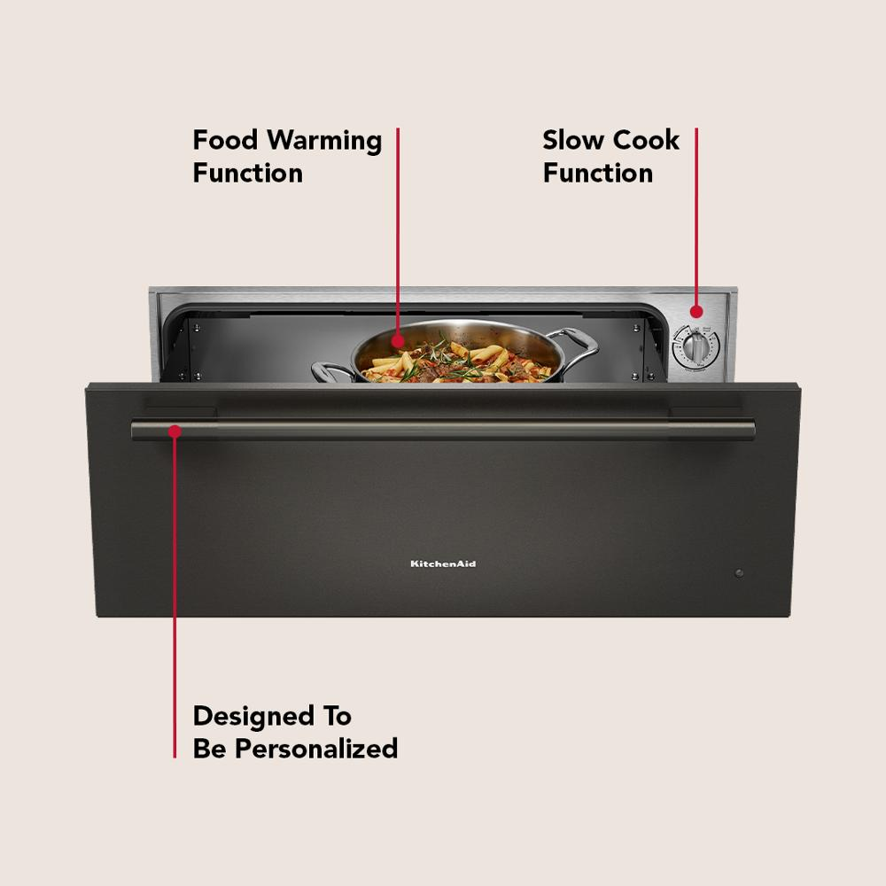 Matte black slow cook warming drawer with stainless steel handle and control knob for wall oven kitchens and appliances.