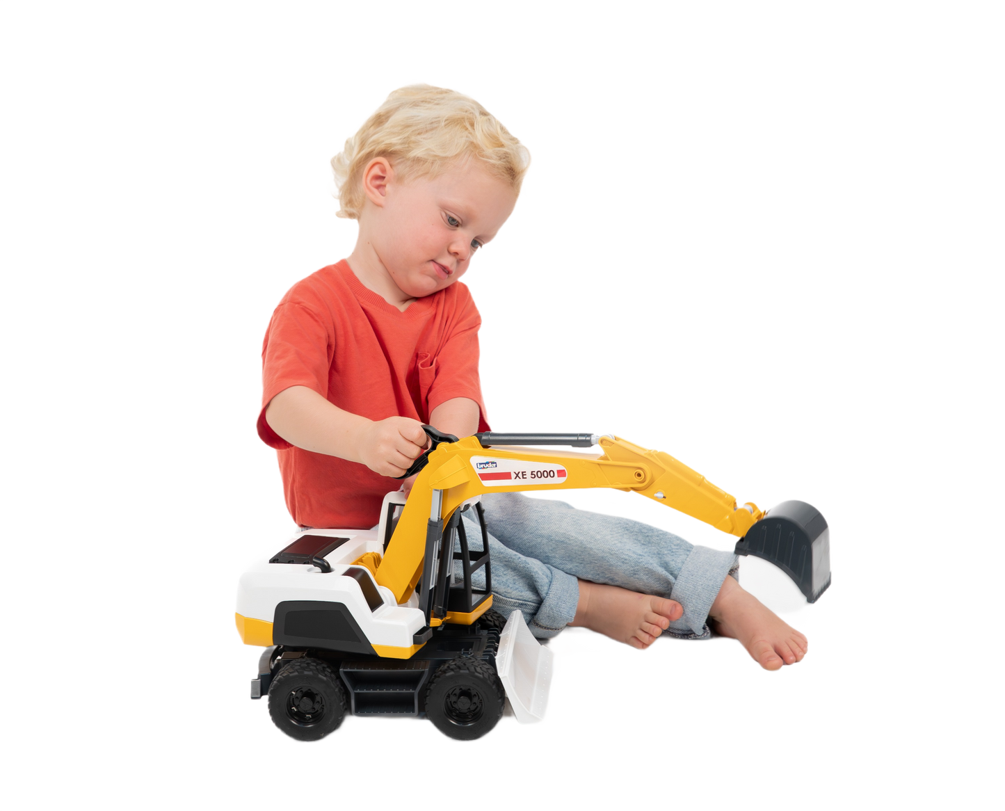 Child playing with yellow and white Bruder XE 5000 Excavator toy with movable arm and bucket for imaginative play