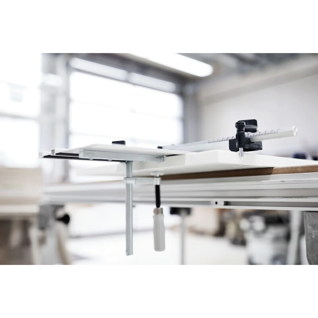 Sliding edge stop system with adjustable guide rail mounted on woodworking bench for precise hole drilling tasks