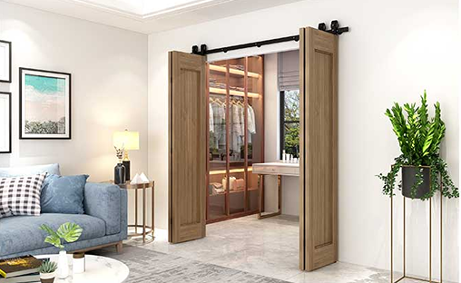 Black flat track hardware with polymer wheels installed on wooden bifold doors in modern home interior