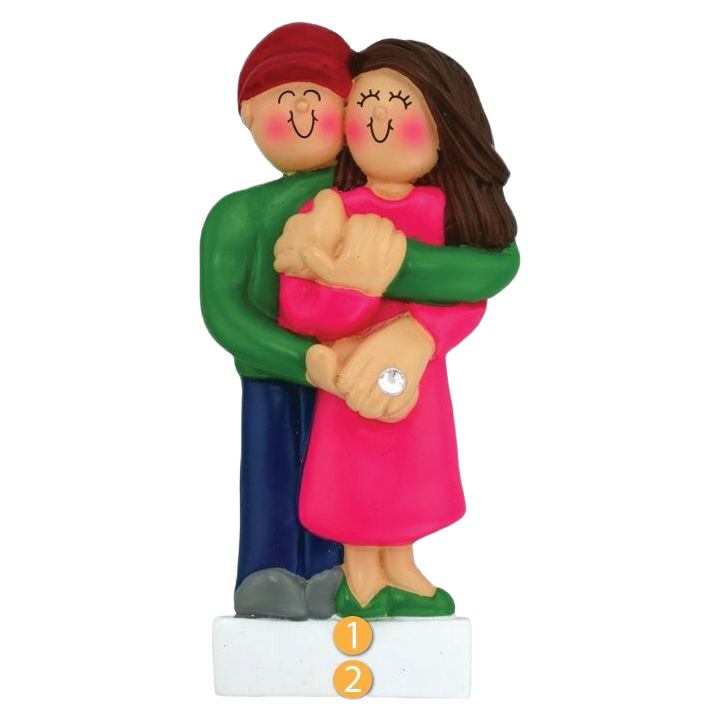 Figurine ornament of a smiling brunette woman in pink and man in green celebrating engagement in Christmas collection under $50
