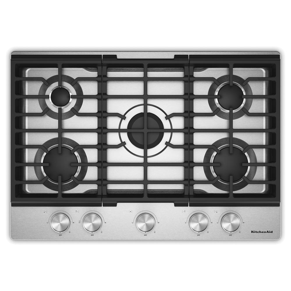 Top view of a stainless steel cooktop with five burners and cast-iron grates, featuring five metal control knobs, part of KitchenAid gas cooktops for kitchenware and home improvement.