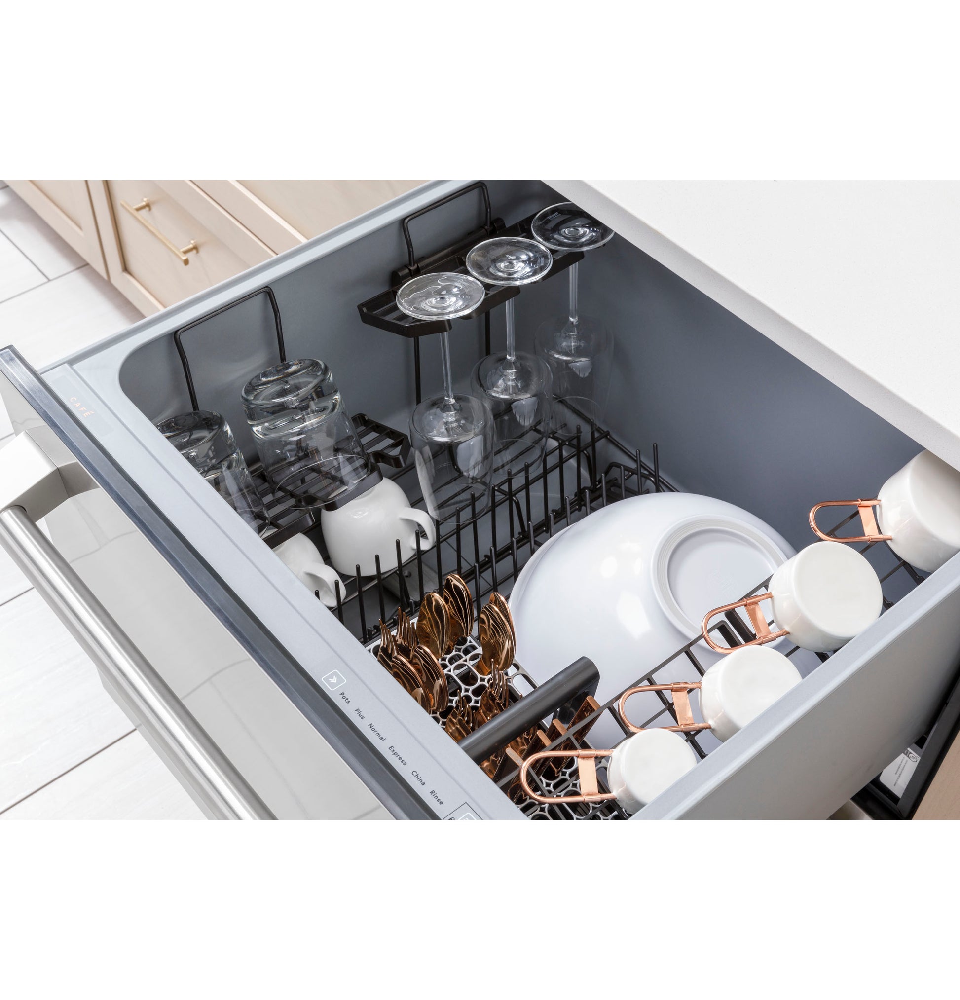 Open smart single drawer dishwasher loaded with wine glasses, mugs, bowls, and cups in light modern kitchen setting