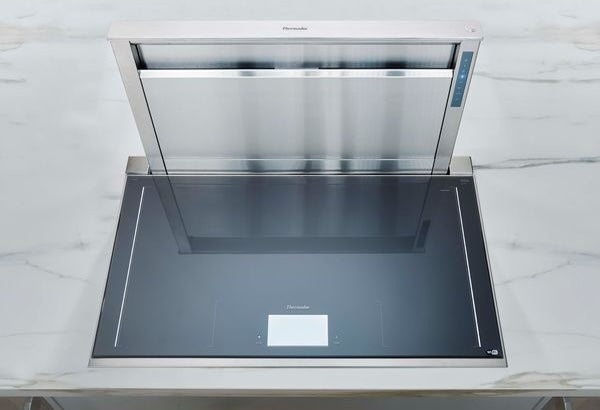 Stainless steel downdraft ventilation system installed in sleek kitchen countertop for home improvement use