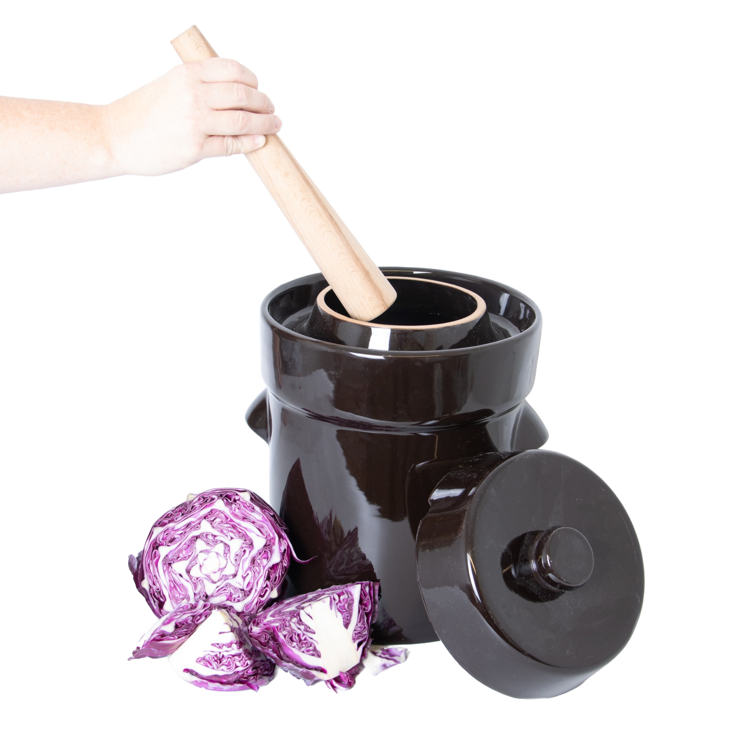 Light wooden dual-sided stomper tool inside a dark ceramic crock with purple cabbage for kitchenware under $50 collections