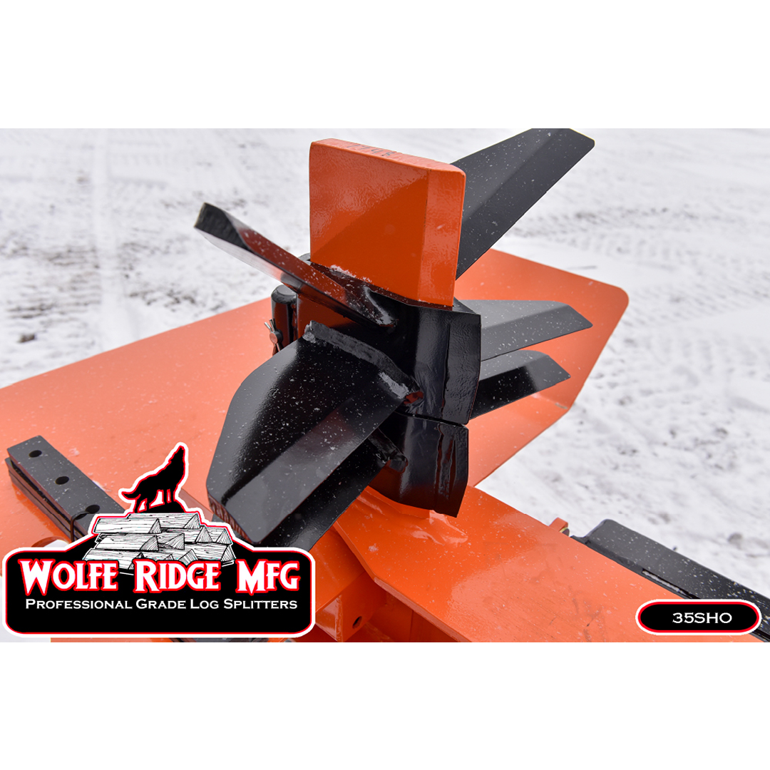Close-up of heavy-duty orange and black log splitter wedge designed for fast splitting of large logs outdoors in snow