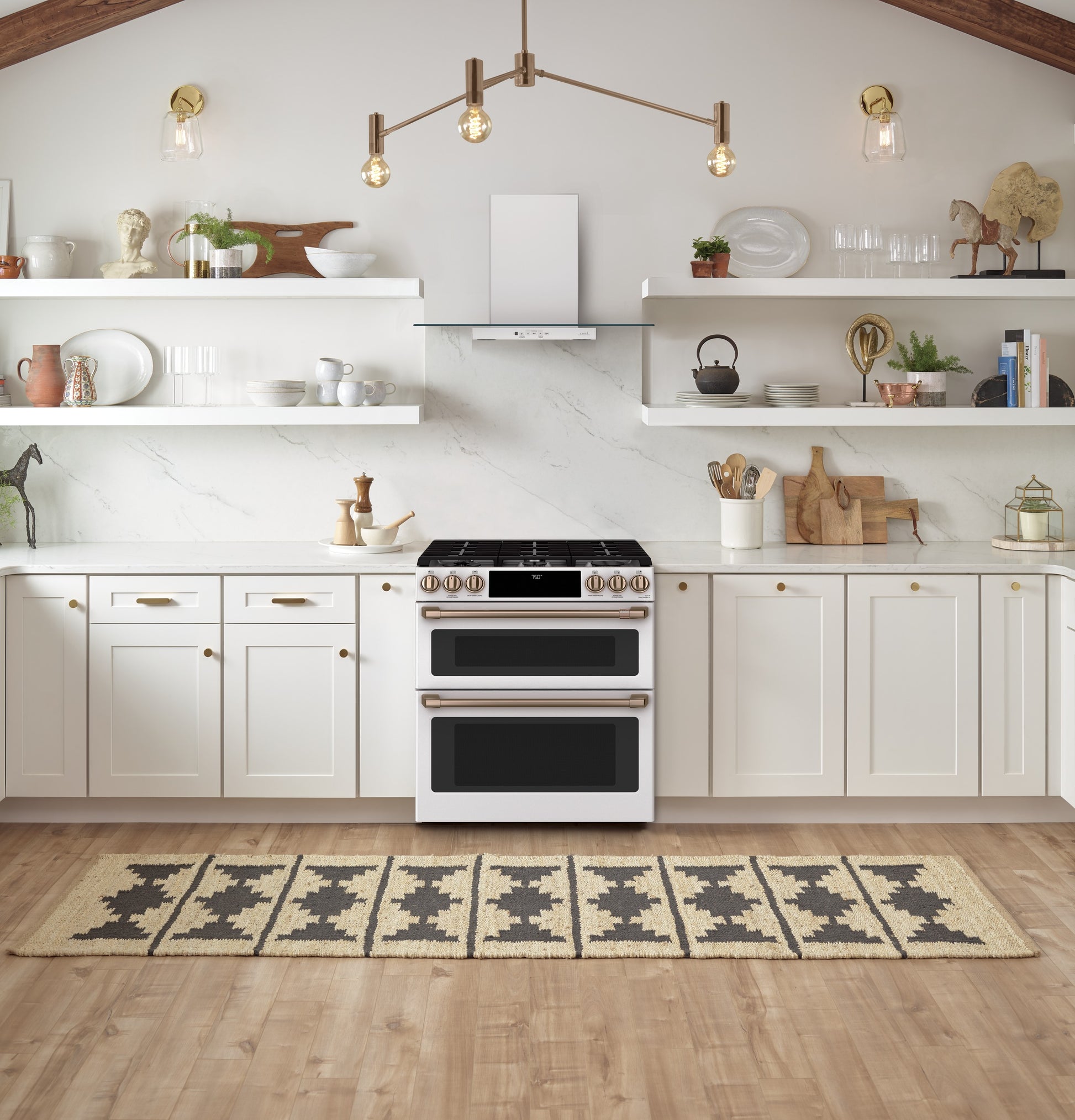 White smart slide-in gas double-oven range with bronze-tone knobs in bright kitchen from Ranges & Kitchenware collection