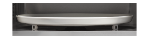 White carousel tray inside black convection countertop microwave oven cavity for kitchen appliance use