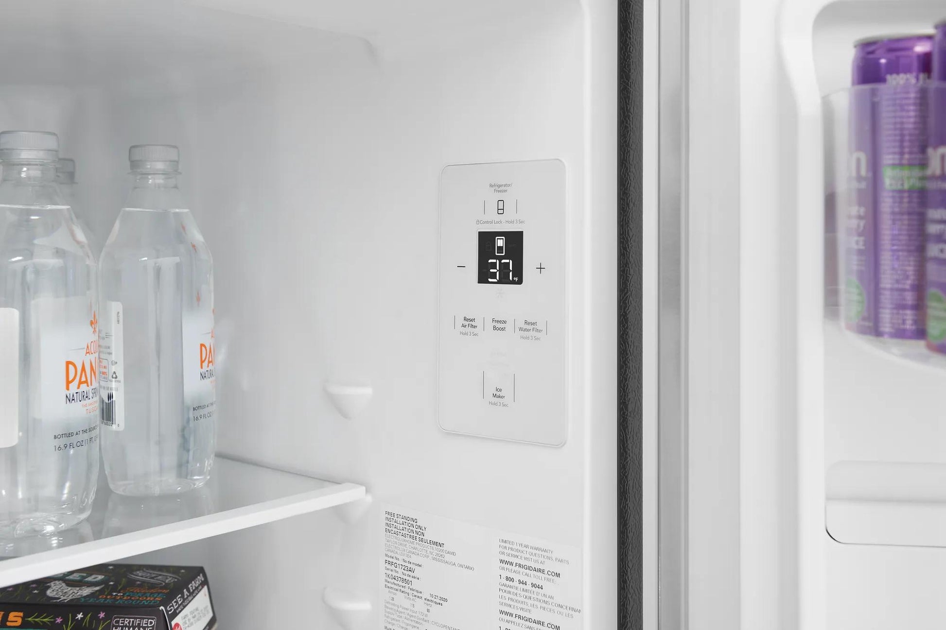 Interior view of refrigerator control panel with adjustable temperature settings and bottled water inside door fridge section