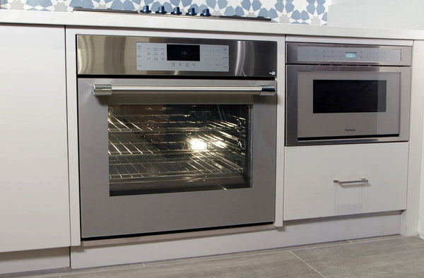 Built-in stainless steel double wall oven with digital controls installed in modern kitchen cabinetry in Appliances collection