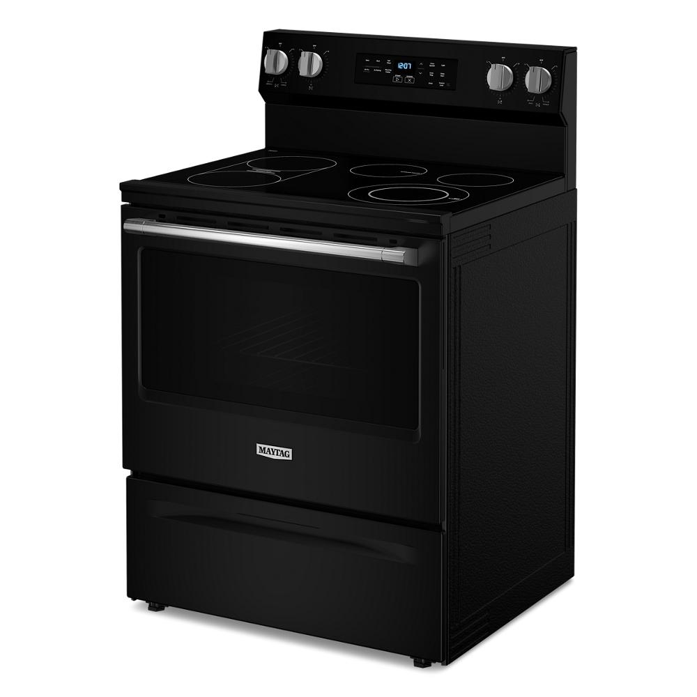 Black electric range with smooth glass cooktop, digital display, and metallic control knobs in kitchen appliances collections