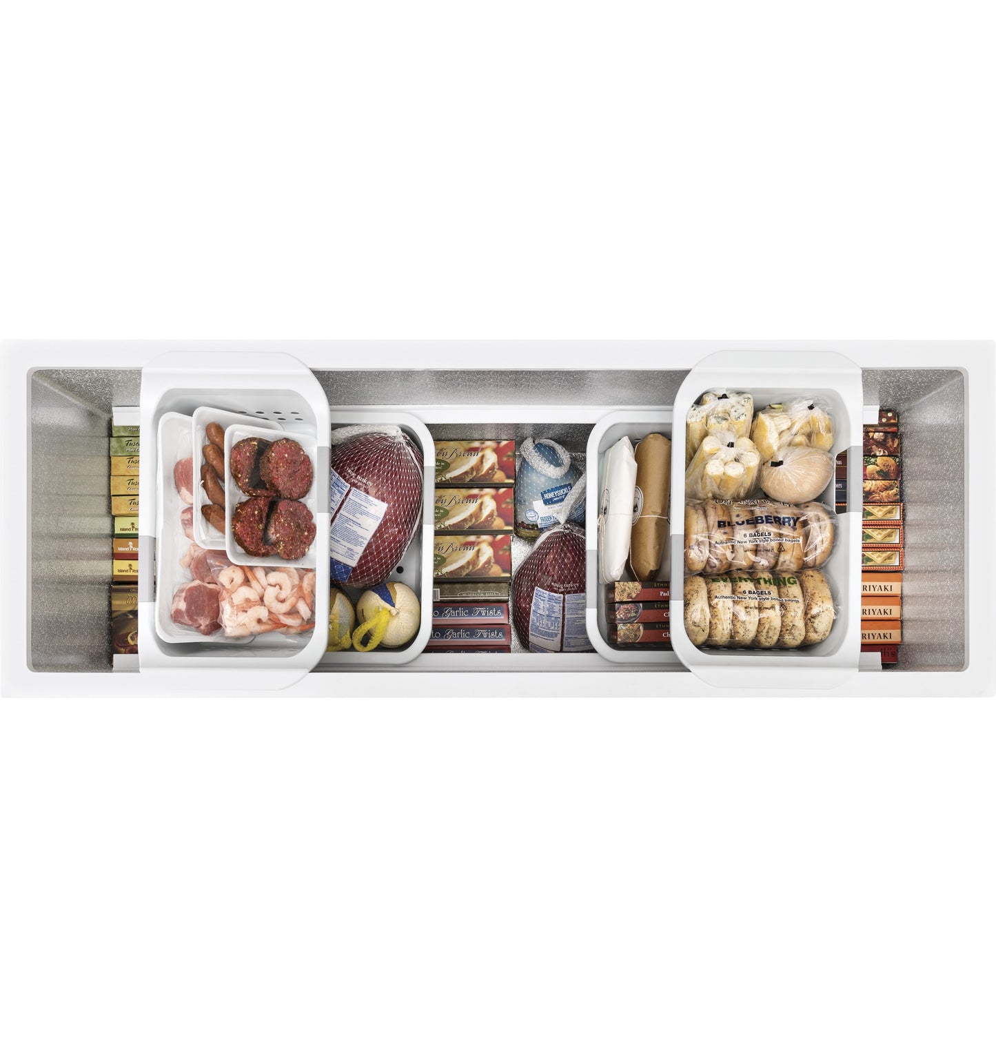 Top view of manual defrost chest freezer filled with various frozen foods in organized baskets for kitchen storage.
