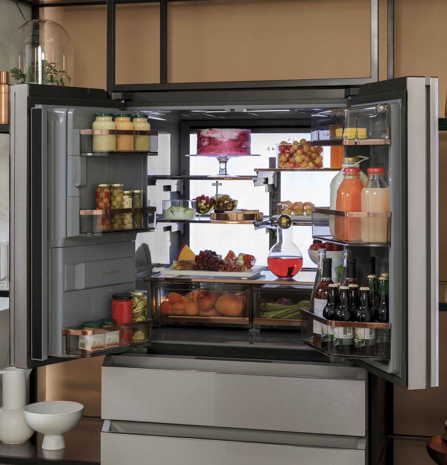 Open platinum glass smart French-door refrigerator with organized shelves storing beverages, produce, and condiments from kitchen appliances collection