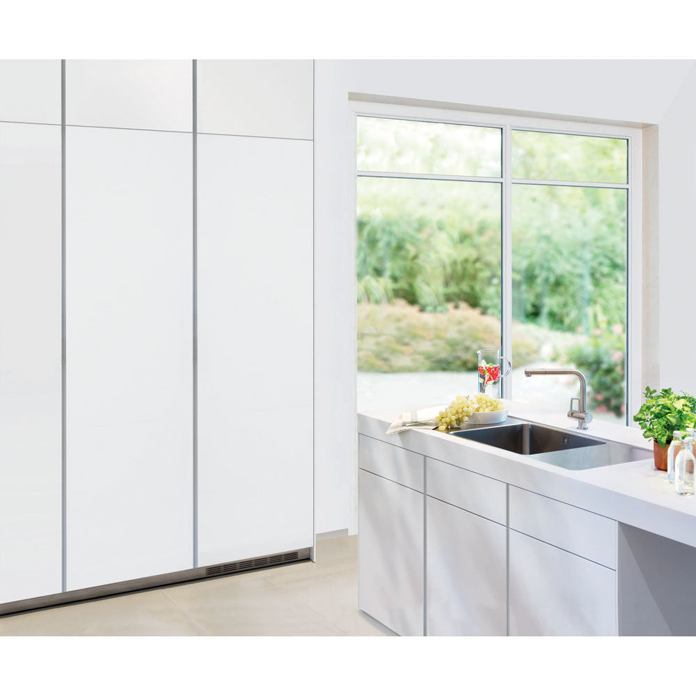 Minimalist kitchen corner with built-in freezer and sleek cabinetry near large window in appliances collection