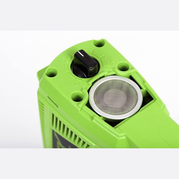Close-up of green cordless brad nailer adjustment dial and metal mesh vent for safe home improvement use