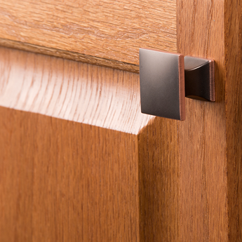 Square oil rubbed bronze knob on wood cabinet door for hardware and furniture accessories under $50 collection