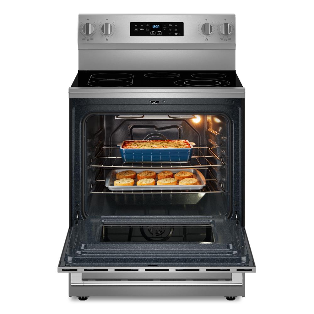 Stainless steel electric range with open oven door showing baked casserole and biscuits inside from kitchen appliances collection
