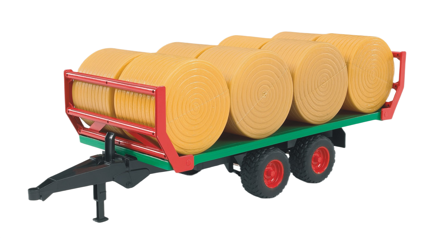 Flatbed trailer loaded with round yellow hay bales arranged in rows for agricultural transport use