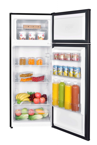 Open mid-size refrigerator with manual defrost, adjustable shelves, crisper drawer, filled with beverages and fresh produce in kitchen appliances collection