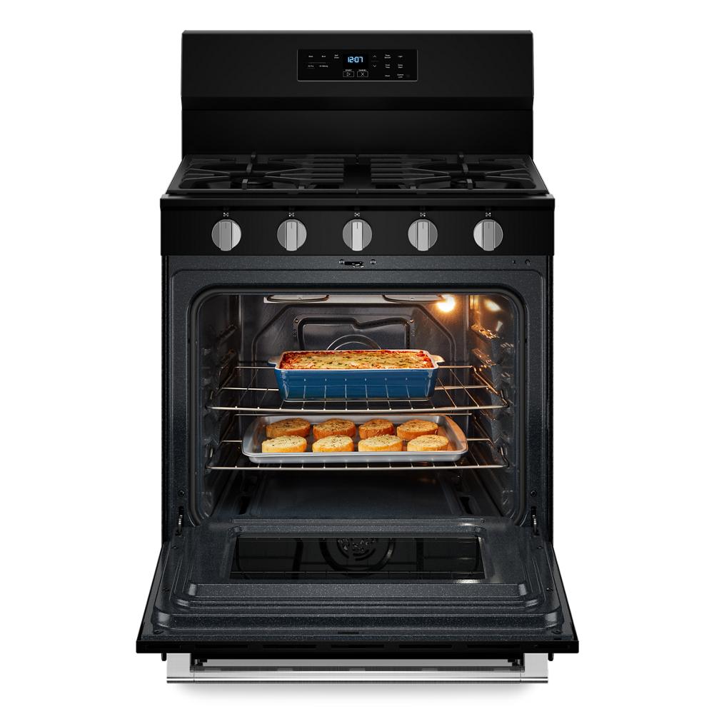 30-inch black gas range with open oven door baking casserole and rolls, suitable for home improvement kitchens and appliances