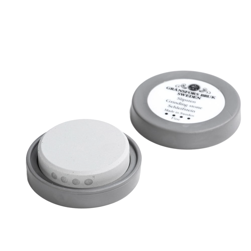 Gray container holding a fine white ceramic grinding stone for woodworking tool accessories and home improvement use