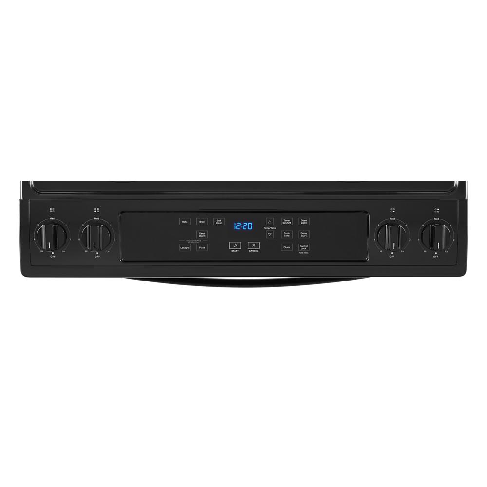 Control panel of black Whirlpool electric range with digital display and four burner control knobs for kitchen appliances