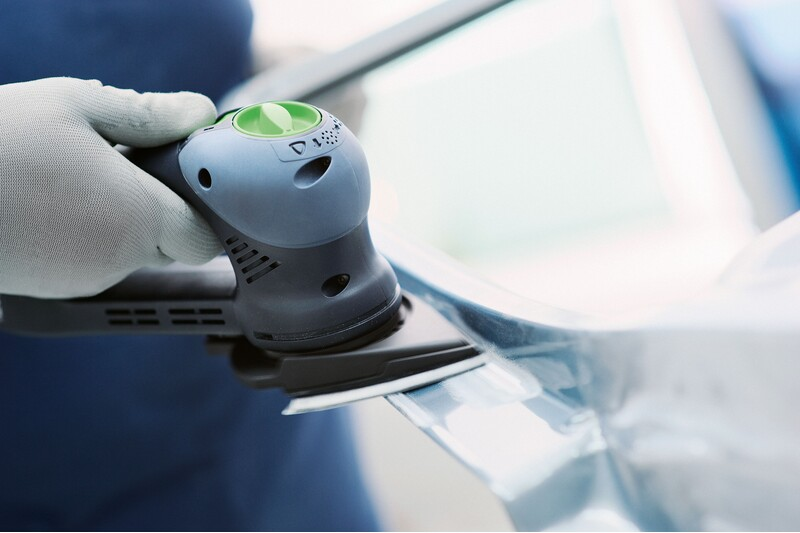 Person using a Festool Rotex RO 90 delta sanding pad on a curved surface in woodworking tool accessories collection