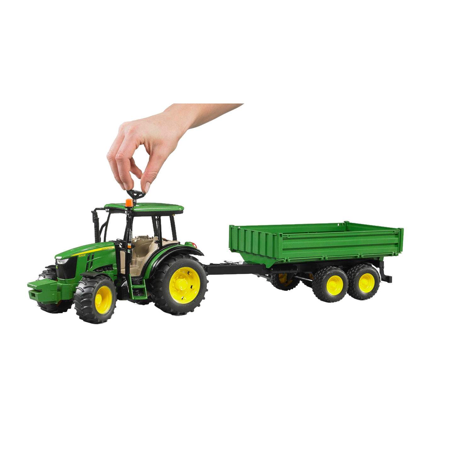 Hand placing orange beacon on green tractor toy pulling matching green trailer in Vehicles & Remote Controlled Toys collection