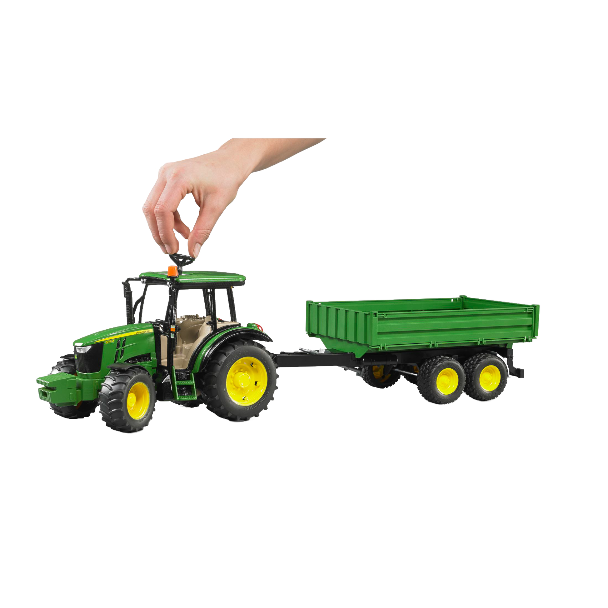 Hand placing orange beacon on green tractor toy pulling matching green trailer in Vehicles & Remote Controlled Toys collection