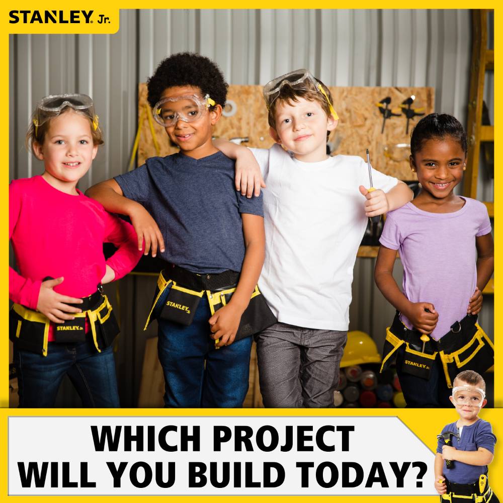 Group of children wearing Stanley Jr. tool belts and safety goggles ready for a home improvement project together