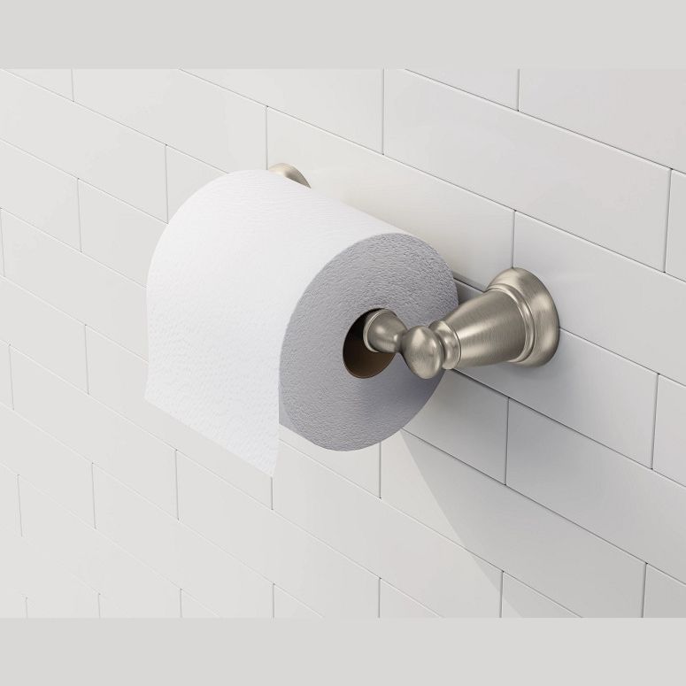 Brushed nickel pivoting toilet paper holder mounted on tiled wall for bathroom organization and home improvement