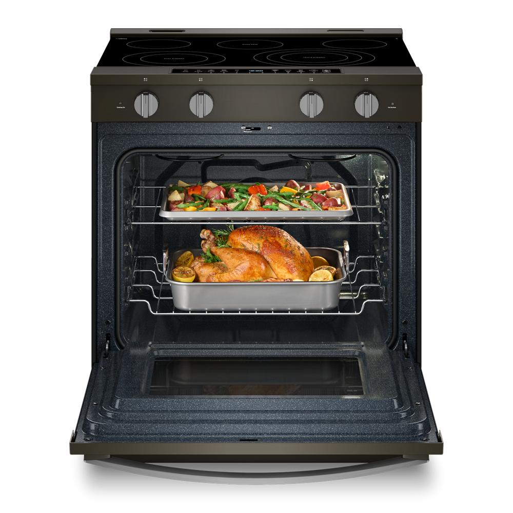 30-inch electric slide-in range with open oven showing roasted chicken and vegetables on racks from kitchen appliances collection