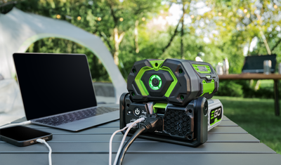 Portable green and black 400W inverter with multiple USB ports powering devices for outdoor tools and home improvement use