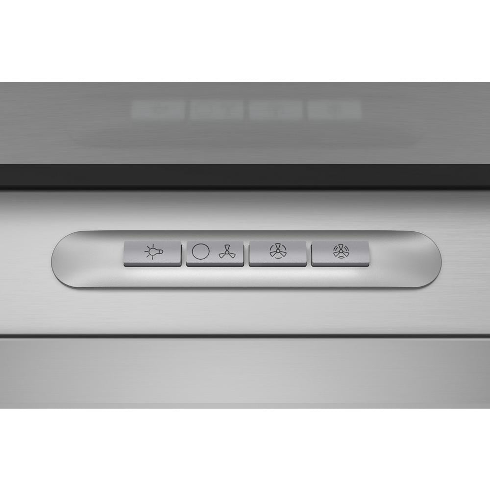 Close-up of stainless steel range hood control panel with buttons for light and three fan speeds from kitchen appliances collection