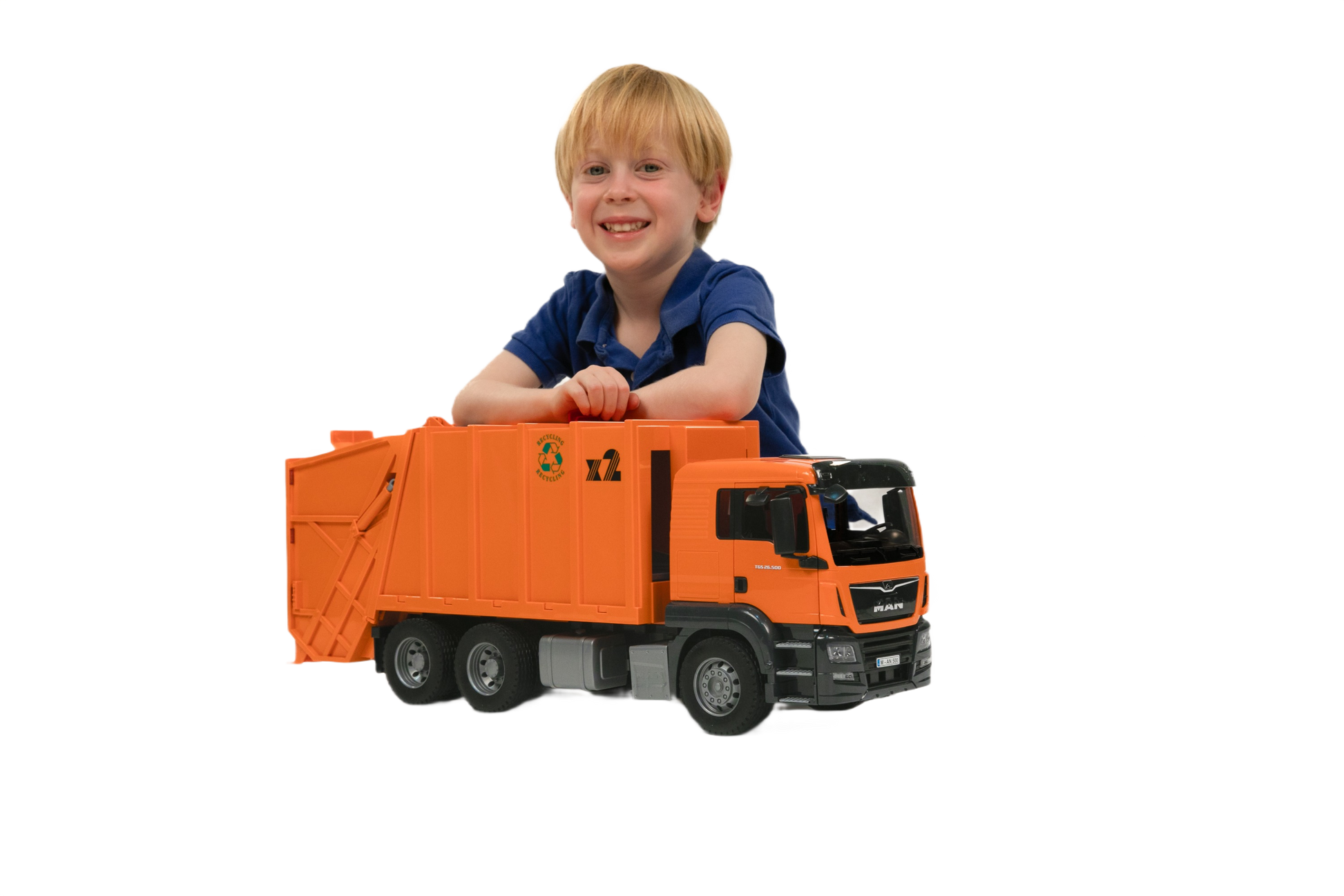 Child smiling while playing with detailed orange Bruder MAN TGS garbage truck toy for imaginative playtime