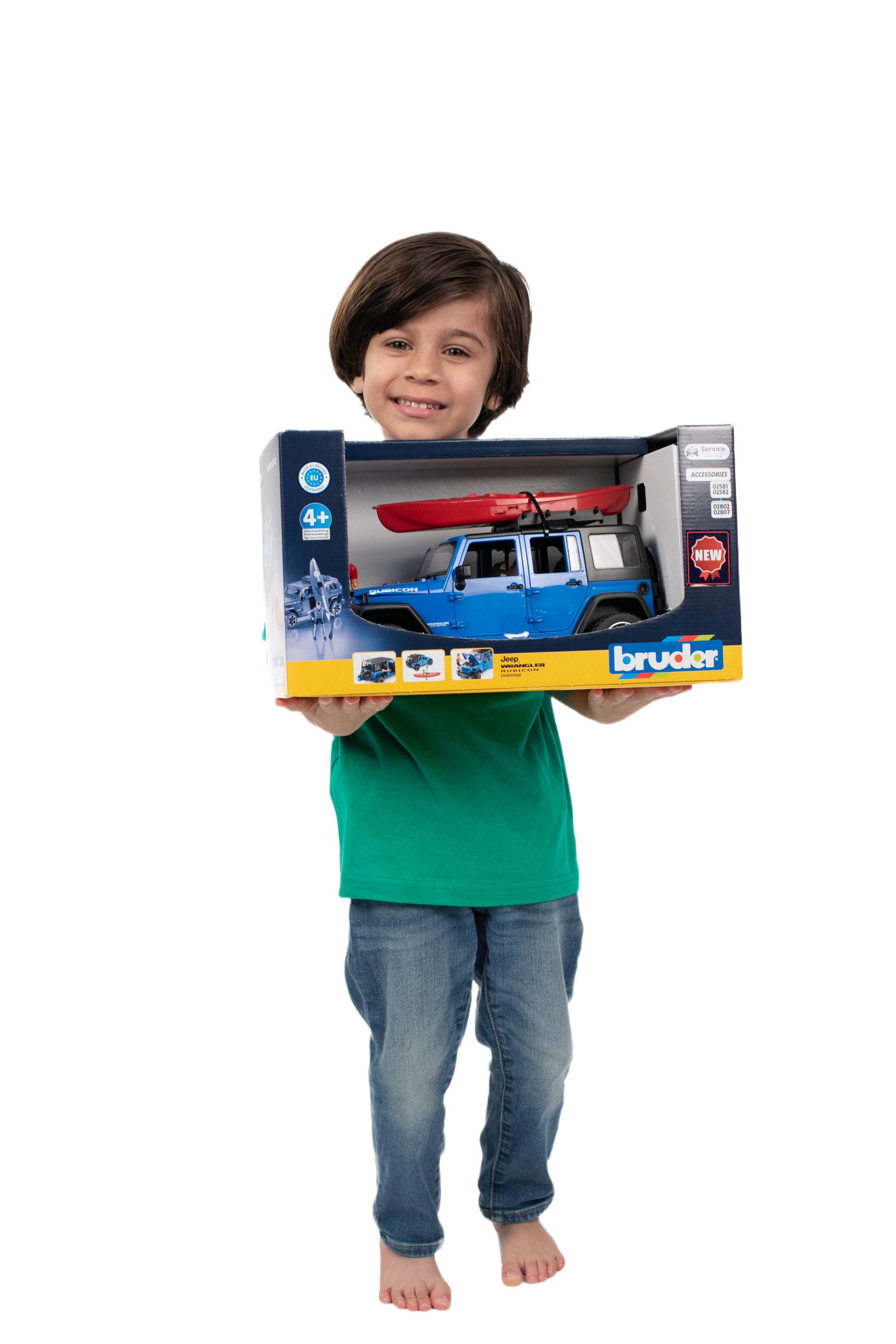 Child holding Bruder blue Jeep Wrangler Rubicon toy with red kayak in branded packaging box