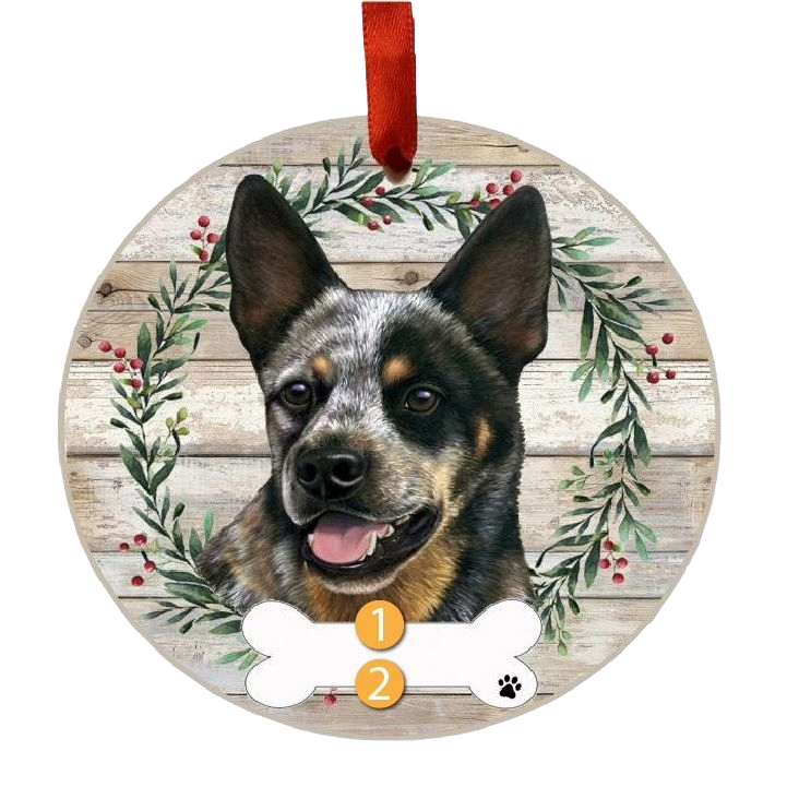 Round Christmas ornament with Australian Cattle Dog face and festive wreath on rustic wooden background