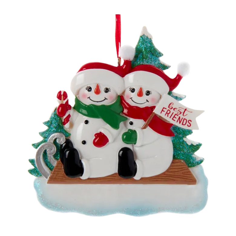 Two smiling snowmen wearing scarves and hats sitting on sled with evergreen trees for Christmas decoration collections