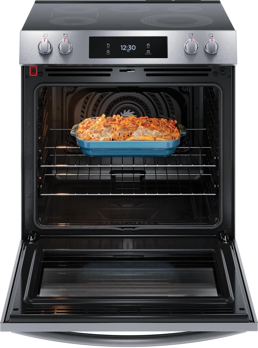Open front control electric range with convection oven baking pasta dish in blue casserole in kitchen collection