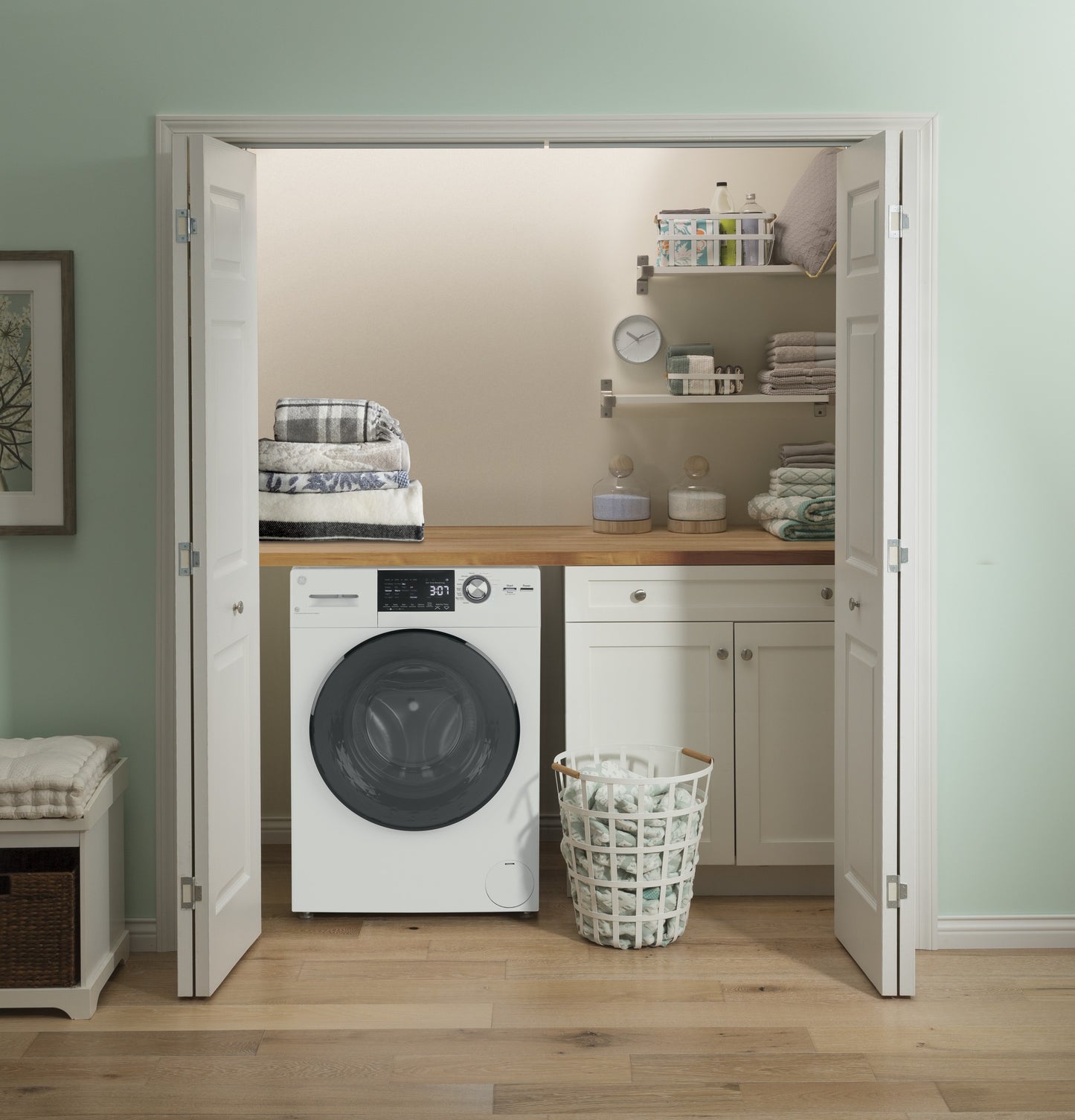 Laundry nook with white front load washer combo under wooden countertop and organized shelves in Washer/Dryer Combos collection